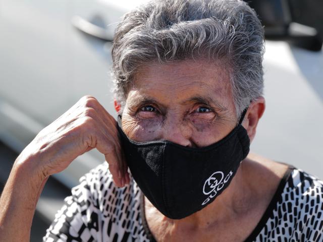 Masked elderly woman